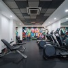 Gym with fitness machines and a bright inspirational mural.